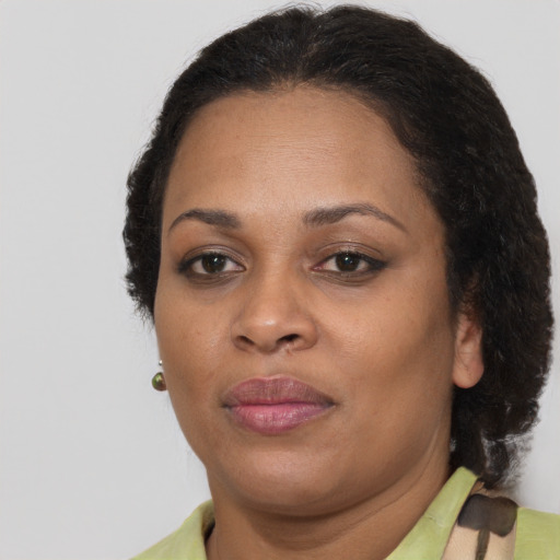 Joyful black adult female with short  brown hair and brown eyes