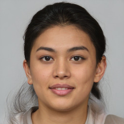 Joyful asian young-adult female with medium  brown hair and brown eyes