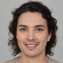 Joyful white young-adult male with medium  brown hair and brown eyes