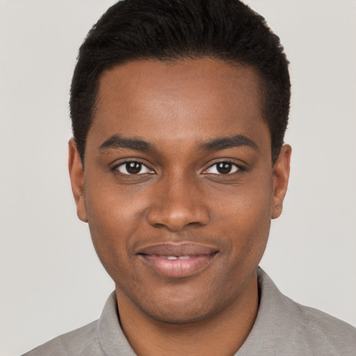 Joyful black young-adult male with short  black hair and brown eyes