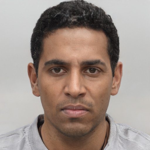 Neutral black young-adult male with short  black hair and brown eyes