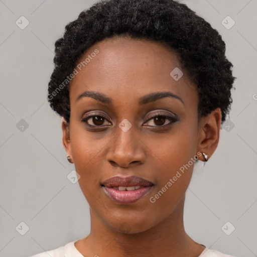 Joyful black young-adult female with short  black hair and brown eyes