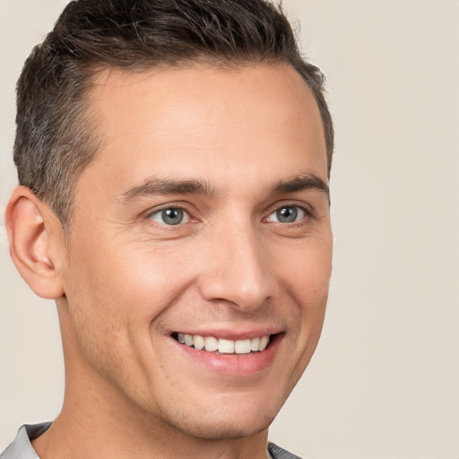 Joyful white young-adult male with short  brown hair and brown eyes