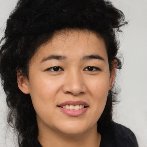 Joyful asian young-adult female with long  brown hair and brown eyes