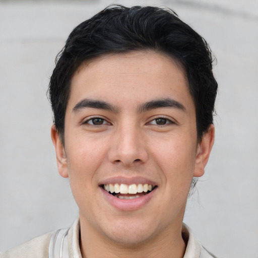 Joyful latino young-adult male with short  brown hair and brown eyes