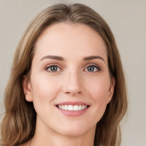 Joyful white young-adult female with long  brown hair and green eyes