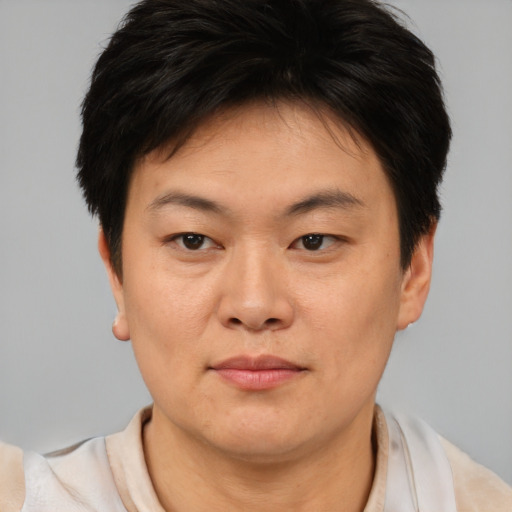 Joyful asian young-adult female with short  brown hair and brown eyes