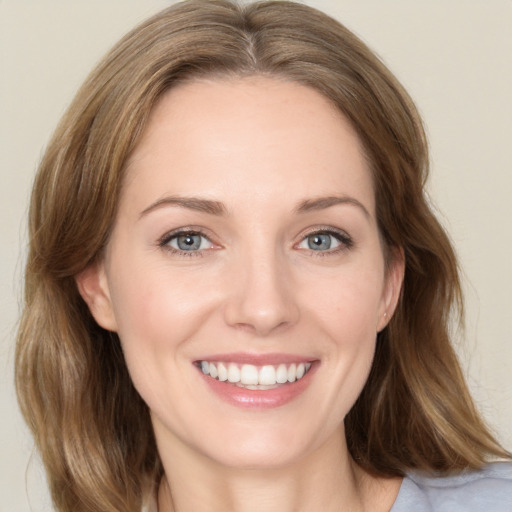 Joyful white young-adult female with medium  brown hair and green eyes