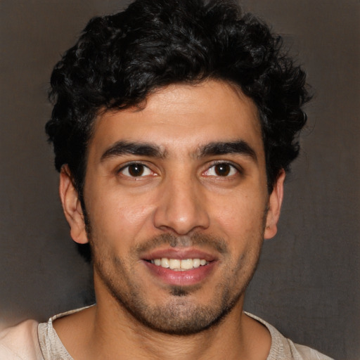 Joyful latino young-adult male with short  black hair and brown eyes