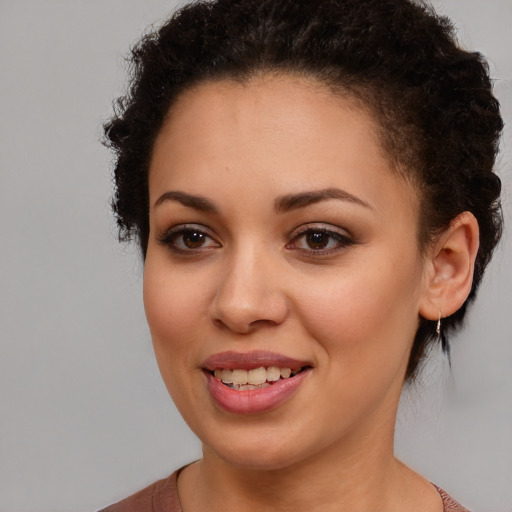 Joyful black young-adult female with medium  brown hair and brown eyes