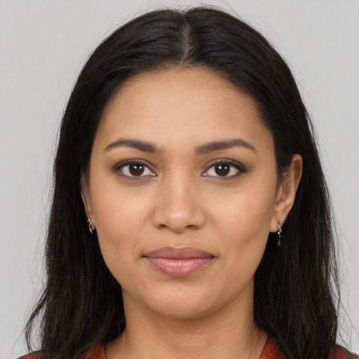 Joyful latino young-adult female with long  black hair and brown eyes