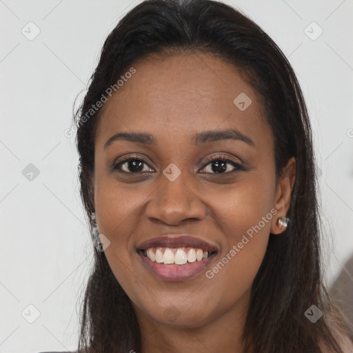 Joyful black young-adult female with long  brown hair and brown eyes