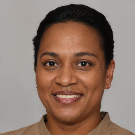 Joyful black adult female with short  black hair and brown eyes