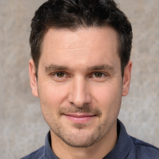 Joyful white adult male with short  brown hair and brown eyes