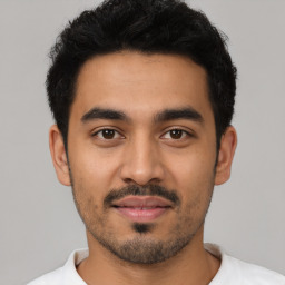 Neutral latino young-adult male with short  black hair and brown eyes