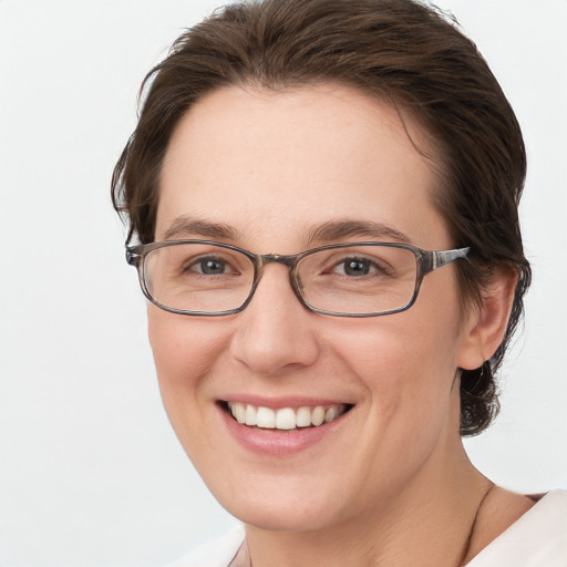 Joyful white young-adult female with short  brown hair and grey eyes