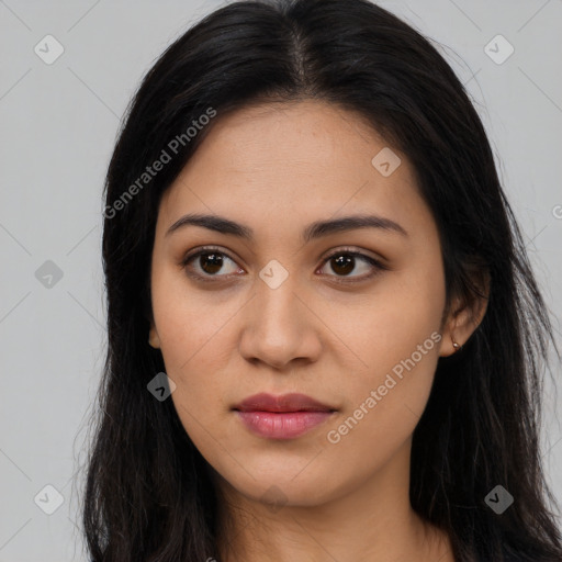 Joyful latino young-adult female with long  black hair and brown eyes