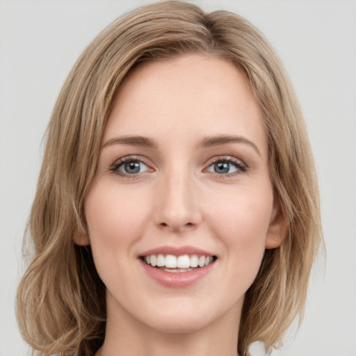 Joyful white young-adult female with medium  brown hair and green eyes