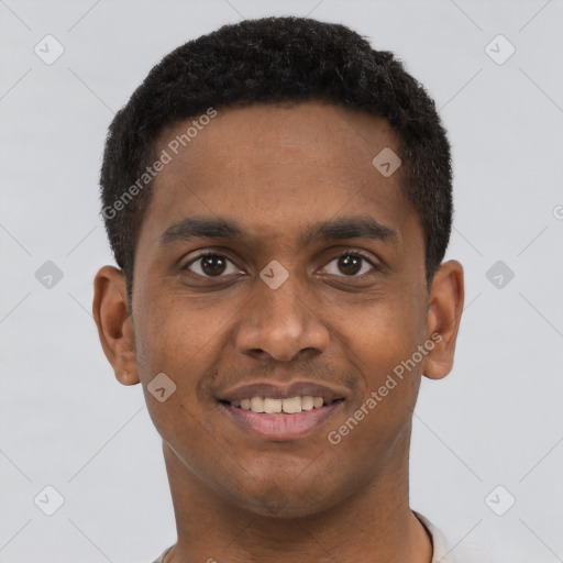 Joyful black young-adult male with short  brown hair and brown eyes