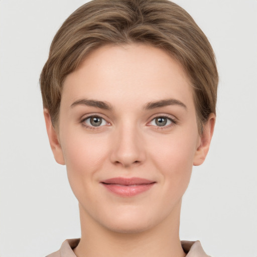 Joyful white young-adult female with short  brown hair and grey eyes