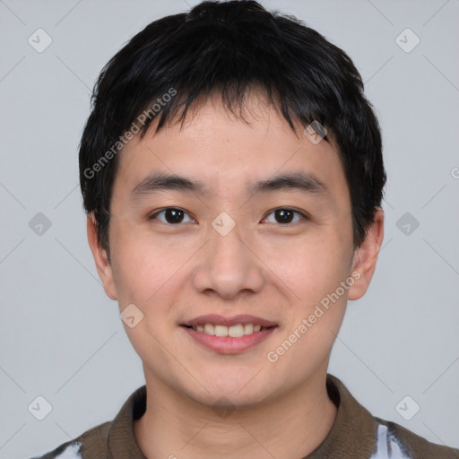 Joyful asian young-adult male with short  black hair and brown eyes