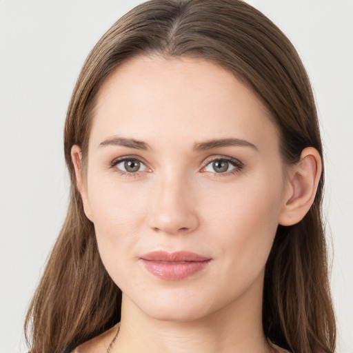 Joyful white young-adult female with long  brown hair and grey eyes