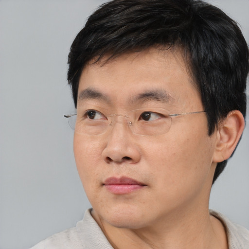Neutral asian adult male with short  black hair and brown eyes