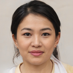 Joyful asian young-adult female with medium  brown hair and brown eyes