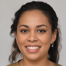 Joyful latino young-adult female with medium  brown hair and brown eyes