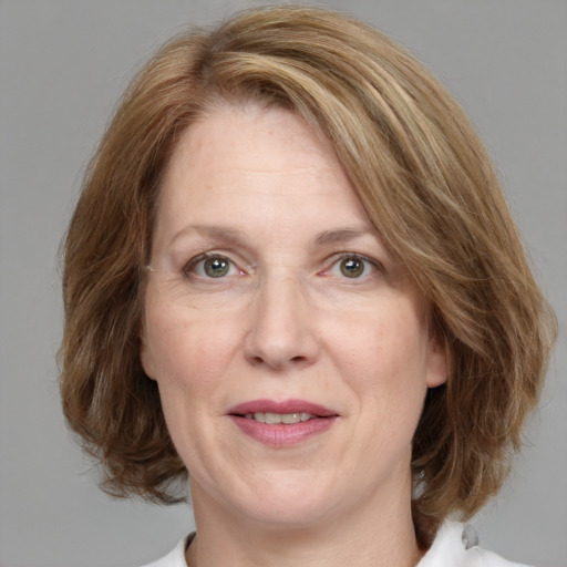 Joyful white adult female with medium  brown hair and blue eyes