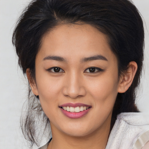 Joyful asian young-adult female with medium  brown hair and brown eyes