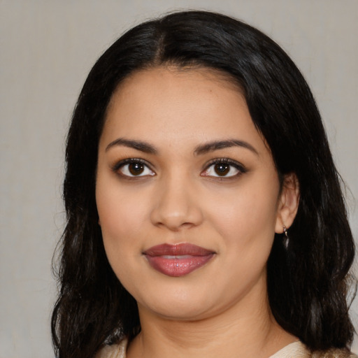 Joyful latino young-adult female with medium  black hair and brown eyes