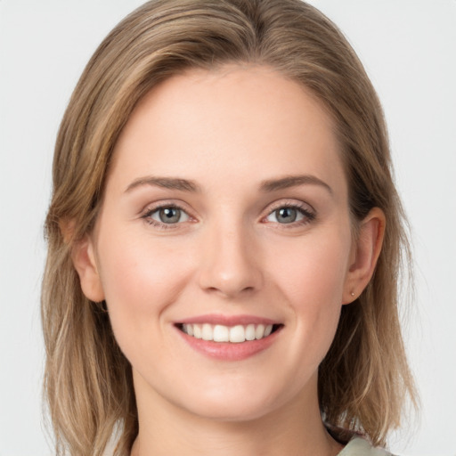 Joyful white young-adult female with medium  brown hair and blue eyes