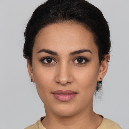 Joyful latino young-adult female with medium  brown hair and brown eyes