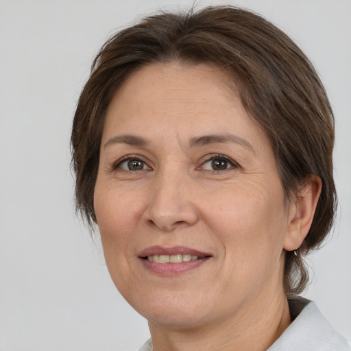 Joyful white adult female with medium  brown hair and brown eyes