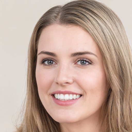 Joyful white young-adult female with long  brown hair and green eyes