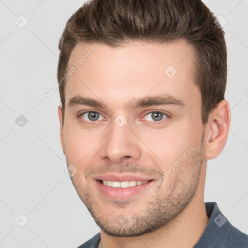 Joyful white young-adult male with short  brown hair and brown eyes