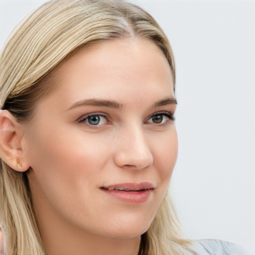 Joyful white young-adult female with long  brown hair and blue eyes