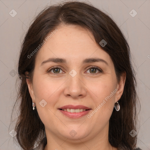 Joyful white adult female with medium  brown hair and brown eyes