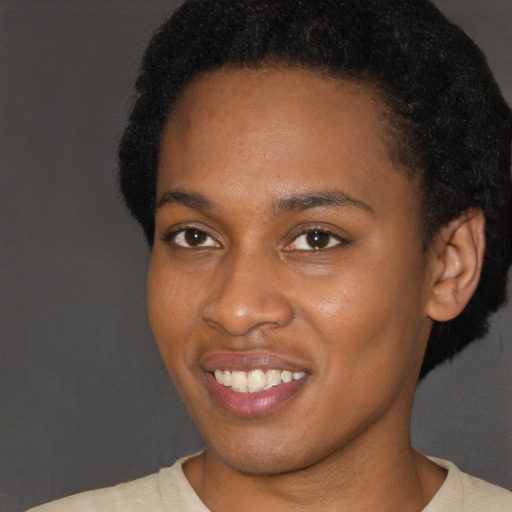 Joyful latino young-adult female with short  black hair and brown eyes
