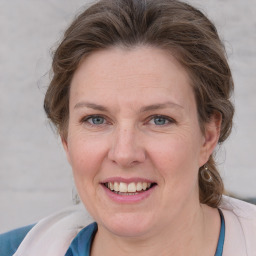 Joyful white adult female with medium  brown hair and grey eyes