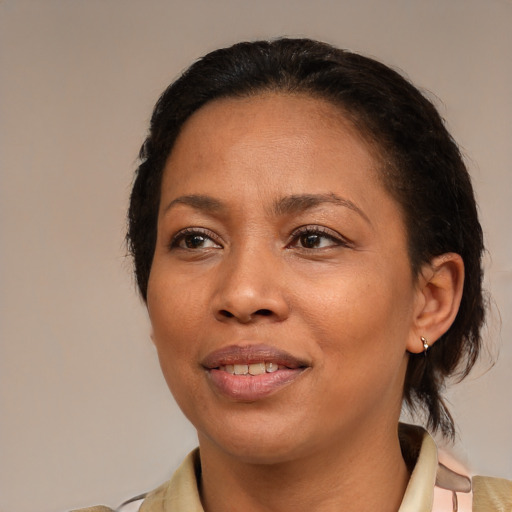 Joyful black young-adult female with medium  brown hair and brown eyes