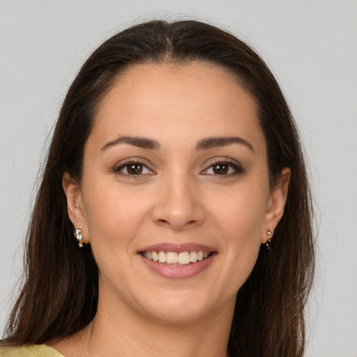 Joyful white young-adult female with long  brown hair and brown eyes