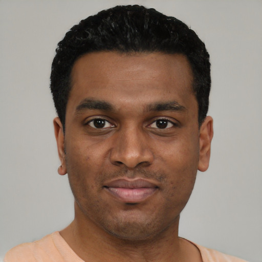 Joyful black young-adult male with short  black hair and brown eyes