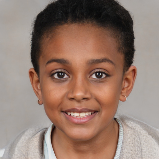 Joyful black child female with short  brown hair and brown eyes