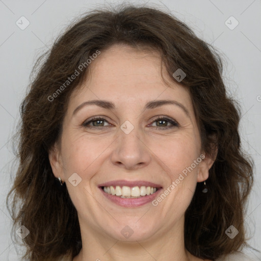 Joyful white adult female with medium  brown hair and green eyes