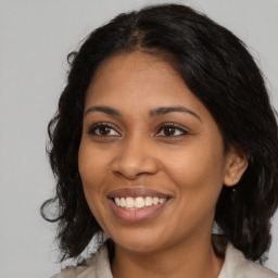 Joyful black young-adult female with medium  brown hair and brown eyes