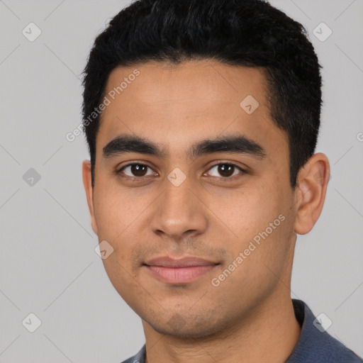 Joyful latino young-adult male with short  black hair and brown eyes