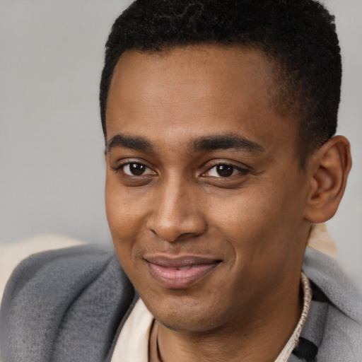 Joyful latino young-adult male with short  brown hair and brown eyes