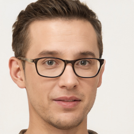 Joyful white young-adult male with short  brown hair and grey eyes